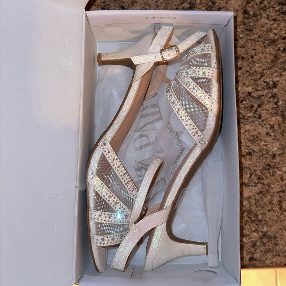 White sparkle shoes with a small heel.